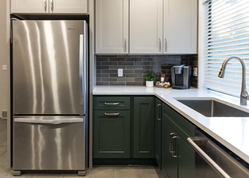 Two-tone cabinetry and coffee station by JL Remodeling with deep green lower cabinets, gray uppers, a gray subway tile backsplash, and quartz counters.