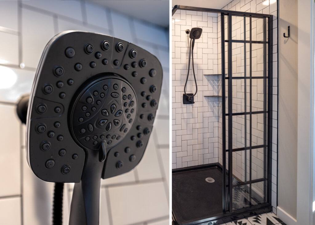 Walk-in shower with white subway tile, a black-framed glass door, black shower pan, and a matte black handheld showerhead.